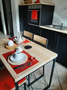 a kitchen with a wooden table with a tableablish at Casa del sole in Ioppolo