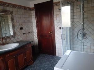 a bathroom with a tub and a sink and a shower at Casa del sole in Ioppolo