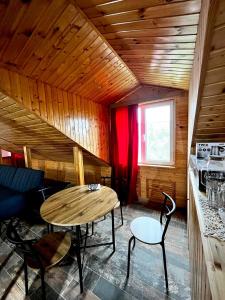 a room with a table and chairs in a cabin at Nino & Irodi's Guest House in Kutaisi +28 photos