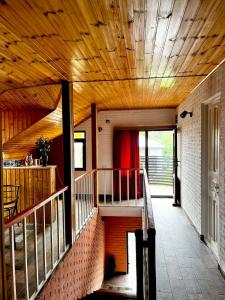 a staircase in a house with a wooden ceiling at Nino & Irodi's Guest House in Kutaisi