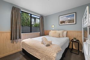 a bedroom with a large bed and a window at Tasman Holiday Parks - Christchurch in Christchurch