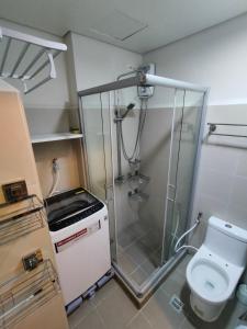 a small bathroom with a shower and a toilet at Coast Residences by Haven Selah in Manila