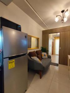 a living room with a refrigerator and a couch at Coast Residences by Haven Selah in Manila