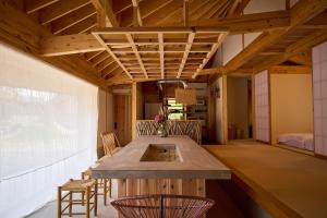 a kitchen with a table and chairs in a room at Villa 天ツ星 in Tahara