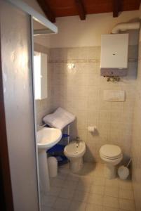 ein kleines Bad mit WC und Waschbecken in der Unterkunft Ferienhaus in Cecina mit Großem Garten in Cecina
