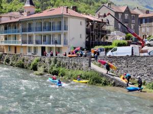 a group of people in kayaks on a river at Maison Nannings in Seix