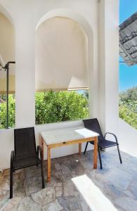 a table and two chairs on a patio at Achlia Sea Side Retreat 1 in Ierápetra
