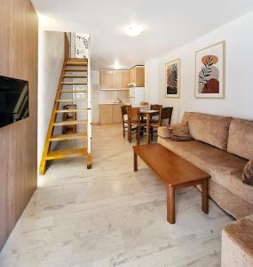 a living room with a couch and a table at Achlia Sea Side Retreat 1 in Ierápetra +52 photos