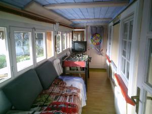een kleine kamer met een bank en een tv. bij Appartement in Innerlehen mit Terrasse, Grill und Garten in Bernau im Schwarzwald