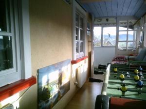 a room with a table and a tv in it at Appartement in Innerlehen mit Terrasse, Grill und Garten in Bernau im Schwarzwald