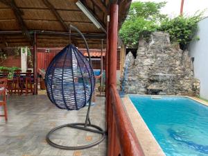 a swimming pool with a swing next to a swimming pool at Country House in Viana
