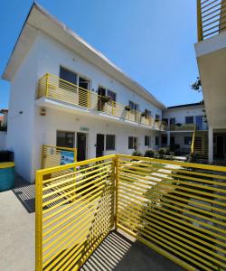 a yellow fence in front of a white building at Casa Maria in Vama Veche