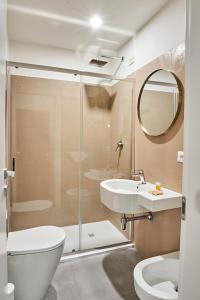 a bathroom with a shower and a toilet and a sink at Hotel Lombardi in Florence