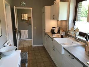 a kitchen with a sink and a counter top at Liebevoll eingerichtetes ebenerdiges Haus mit Charme und Seele und wunderschönem Garten in Hage