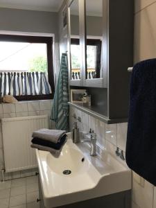 a bathroom with a sink and a mirror and a window at Liebevoll eingerichtetes ebenerdiges Haus mit Charme und Seele und wunderschönem Garten in Hage