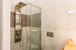 a shower with a glass door in a bathroom at Apartment deluxe ground floor Venice/Treviso park in Silea +26 photos