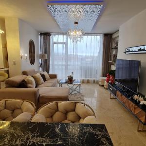 a living room with a couch and a tv at CRISTINCO PANORAMIC in Cluj-Napoca