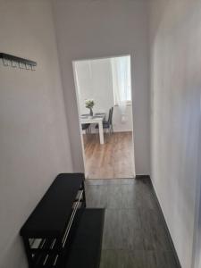a white room with a table and a dining room at Apartmán Anežka -1- in Jičín