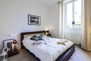 a bedroom with a large bed with a camera on it at DESIGN DISTRICT - Milan Apartment in Milan