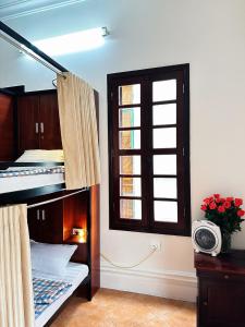 a room with a bunk bed and a window at Tuna Homestay Hanoi & Experience in Hanoi