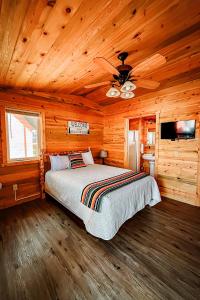 a bedroom with a bed in a wooden cabin at Shell Campground in Shell