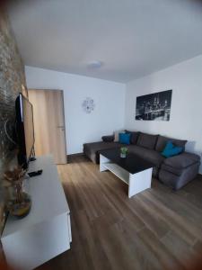 a living room with a couch and a table at Apartmani Gabrijel in Novi Vinodolski