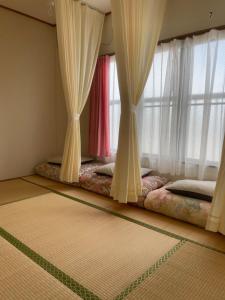 Postel nebo postele na pokoji v ubytování GUESTHOUSE UJIRIVER Kyoto + 32 fotografií