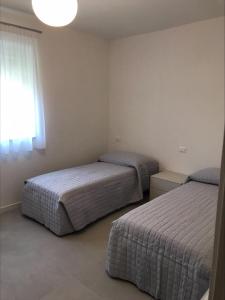 Postel nebo postele na pokoji v ubytování Appartamenti Mare Azzurro