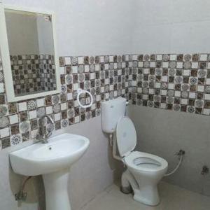 a bathroom with a toilet and a sink at RESIDENCE TULSI in Vrindāvan
