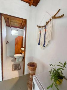 a bathroom with a mirror and a toilet in a room at Atins Beach Houses in Atins