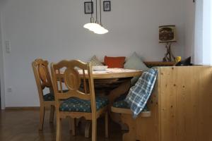 a dining room table with two chairs and a table at Ferienwohnung Vinea in Müllheim