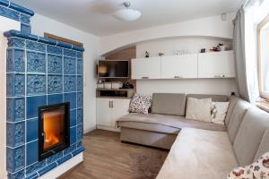 a living room with a couch and a fireplace at Chaty Daniela in Liptovský Ján