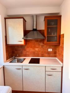 a kitchen with a sink and a stove at Apartments Mirjana in Piran +184 photos