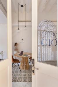 a door to a room with a table and a bird cage at Candelaria10 in Cádiz