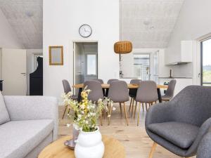 a living room with a table and chairs at 8 person holiday home in Rømø in Kongsmark