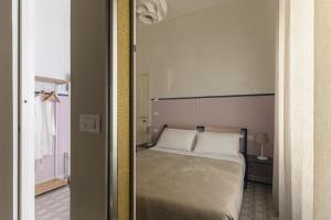 a bedroom with a bed and a mirror at Unico B&B Art Decor in Ostuni