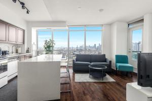 a kitchen and living room with a view of a city at 2 BR with Amazing city views, Free parking and pool in Toronto