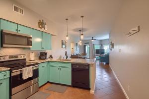 a kitchen with green cabinets and an open floor plan at Ripley River Haus IC 302 in New Braunfels