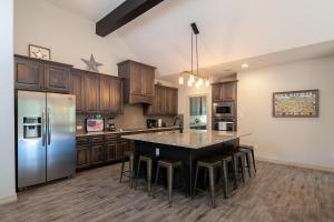a large kitchen with a large island with bar stools at Lazy Southern Getaway in Canyon Lake
