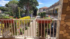 a balcony with a fence with flowers on it at Casa Valdese di Vallecrosia Al Mare in Vallecrosia