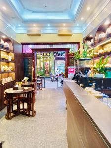 a restaurant with a bar with a table and chairs at Old Quarter Autumn To Tich Ha Noi in Hanoi