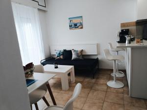 a living room with a couch and a table at Nautilus City Studios & Apartments in Rhodes Town