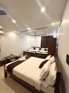 a bedroom with a large bed and two at The Ocean Edge in Puducherry