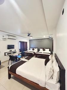sypialnia z 2 łóżkami i pianinem w obiekcie The Ocean Edge w mieście Puducherry