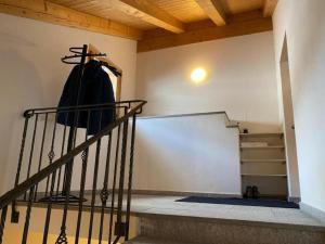 a room with a staircase with a coat hanging on the wall at Haus Suot Chesas 8b ÖV Inklusive in Champfer