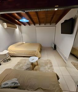 a room with two beds and a flat screen tv at Dúplex Dorrego in Barraquero