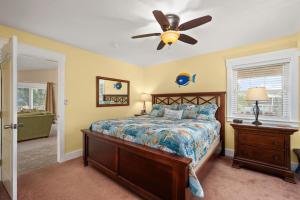 a bedroom with a bed and a ceiling fan at SH101 Reel Catch in Southern Shores