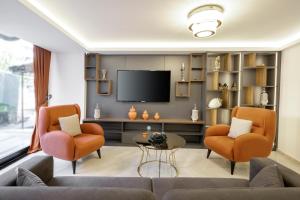 a living room with two chairs and a television at Diamond Beyazit Hotel in Istanbul