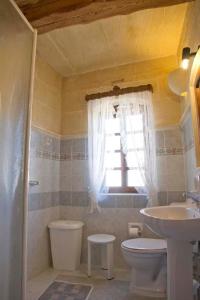 bagno con lavandino, servizi igienici e finestra di Villa Harruba a Xagħra