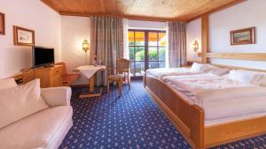 Postel nebo postele na pokoji v ubytování Hotel Alpina